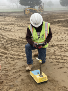 Site technician carrying out a compaction test on prepared subgrade